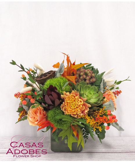 Vase with a succulent plant, peach roses, dianthus, pampas grass, pods, leaves and chrysanthemums