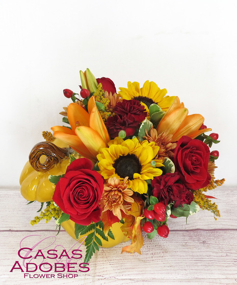 Pumpkin container with sunflowers, roses, fall leaves, carnations, berries and chrysanthemums