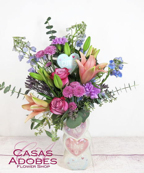 Valentine's Day conversation heart vase with carnations, roses, delphinium and lilies
