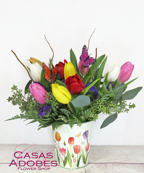 Dozen colorful tulips in keepsake spring tin with accent greenery, curly willow and butterflies