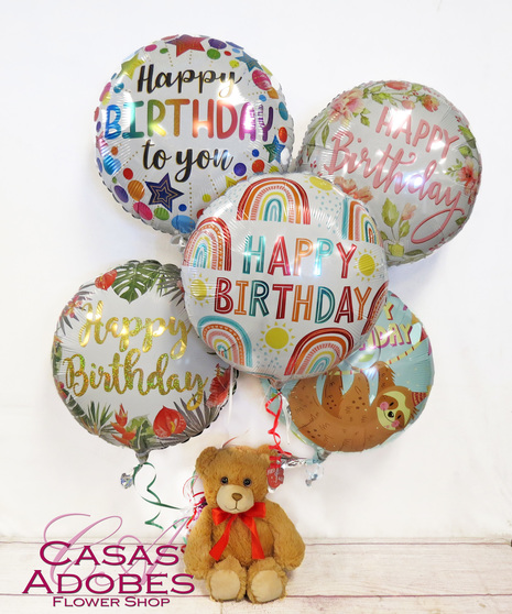 bright latex and mylar balloons for a happy birthday with chocolates and/or teddy bear