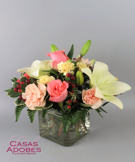 Pastel roses and lilies in a cube vase