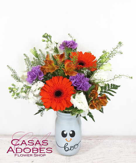 Halloween painted mason jar with orange gerbera daisies, purple carnations, white stock, penny cress, alstroemeria and lisianthus