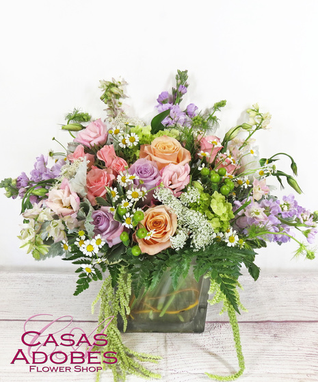 Vase with pastel lavender, peaches and pinks with roses, lisianthus, stock, veronica and dusty miller
