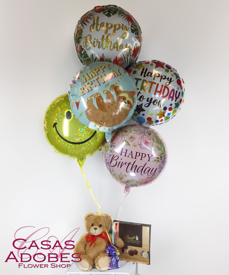 bright latex and mylar balloons for a happy birthday with chocolates and/or teddy bear