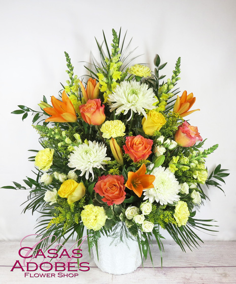 Sympathy Basket with Orange roses, lily, white chrysanthemums, yellow snapdragons, yellow carnations, white spray roses