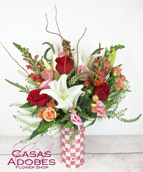 Checkered Valentine's Day vase with lilies, snapdragons, roses, lisianthus and veronica