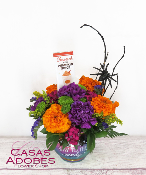 Mirrored cauldron with purple carnations, marigolds, hot pink sweet William and a fun spider on curly willow