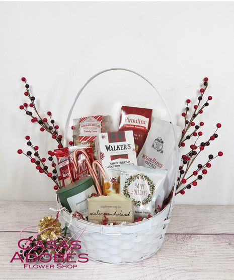 Basket filled with holiday flavors with  holiday coffee , candy canes, gingerbread men cookies, chocolate cookies, peppermint cookies and cocoa