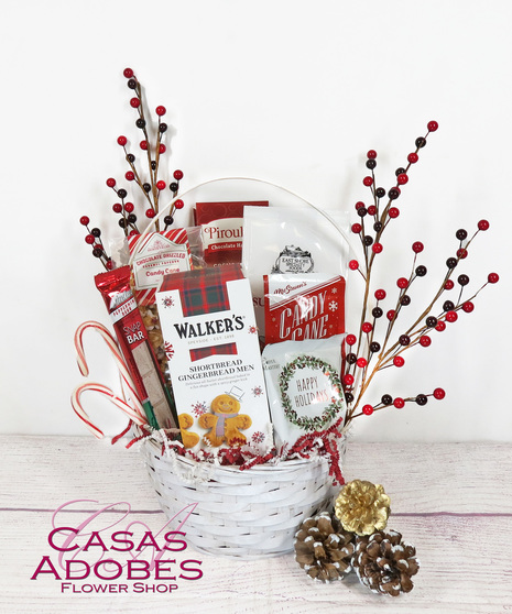 Basket filled with holiday flavors with  holiday coffee , candy canes, gingerbread men cookies, chocolate cookies, peppermint cookies and cocoa