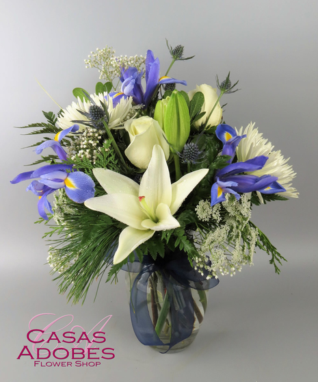 Vase with white flowers and blue iris