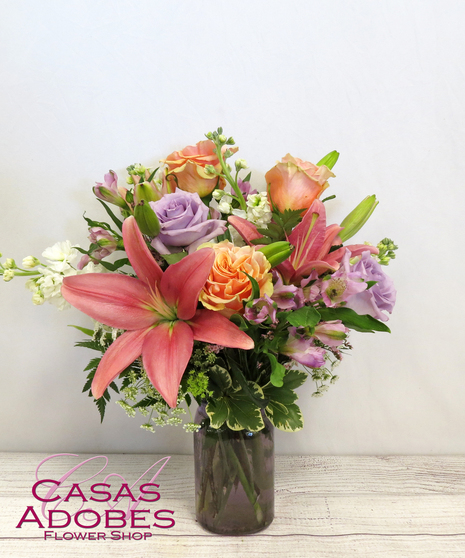 Pastel Wildflowers with white stock, pastel roses, pink lily and peach alstroemeria in a Purple Vase