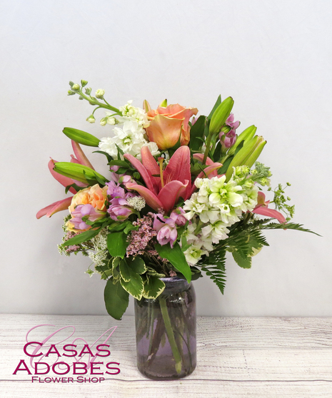 Pastel Wildflowers with white stock, pastel roses, pink lily and peach alstroemeria in a Purple Vase