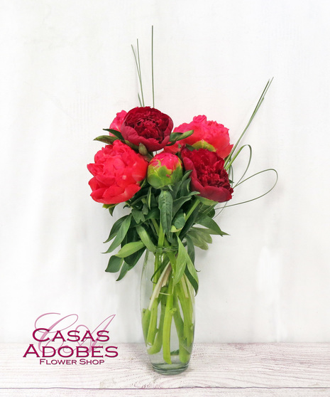 Vase of pink peonies with greenery